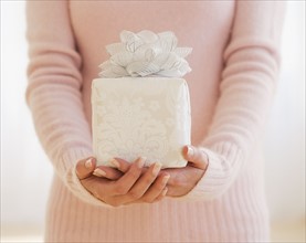 Close up of woman holding gift.