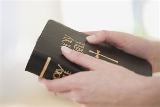 Close up of woman holding Bible.