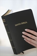 Woman reading Spanish Bible.