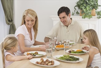 Family eating at dinner table.