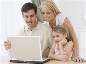Family looking at laptop.