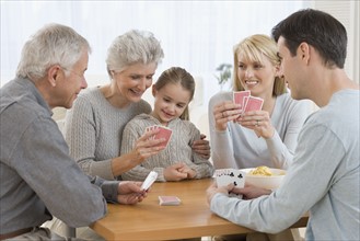 Multi-generational family playing cards.
