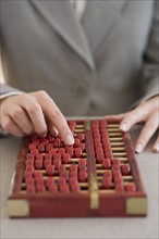 Businesswoman using abacus.
