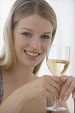 Portrait of woman holding glass of wine.