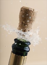 Close up of champagne cork popping.