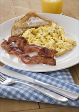 Breakfast plate with eggs and bacon.