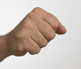 Studio shot of man's hand making fist.
