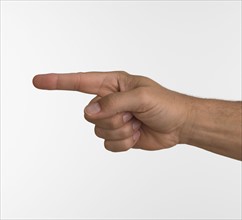 Studio shot of man's hand pointing.