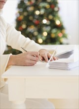 Woman writing Christmas cards.