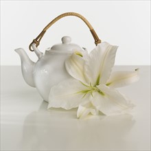 Close up of teapot and flower.
