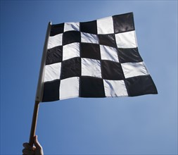 Checkered flag with blue sky.