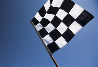 Checkered flag with blue sky.