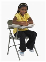 Studio shot of girl doing school work.