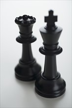 Close up of black chess pieces.