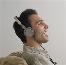 Man sitting and listening to music on headphones.