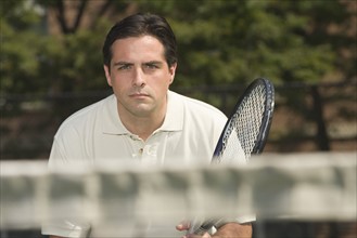 Close up of man playing tennis.