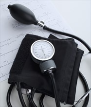 Blood pressure cuff on heart rate printout.