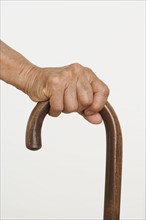 Close up of senior's hand on cane.