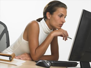 Businesswoman looking at computer screen.
