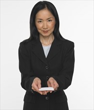 Asian businesswoman offering business card.