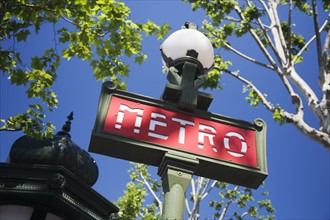 Low angle view of Metro sign on lamp post.