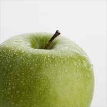 Close up of apple with water droplets.