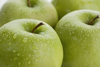 Close up of apples with water droplets.