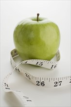Apple and tape measure.