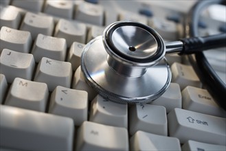 Close up of stethoscope on computer keyboard.