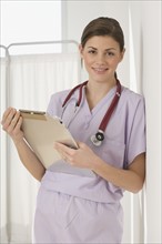 Portrait of female doctor holding chart.