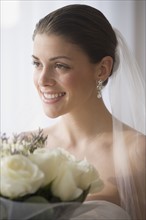 Portrait of bride holding bouquet.