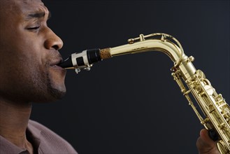 Close up of man playing saxophone.