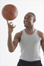 Man spinning basketball on finger.