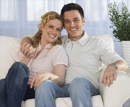 Portrait of couple on sofa.