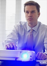 Businessman using projector.