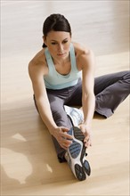 Woman stretching on floor.