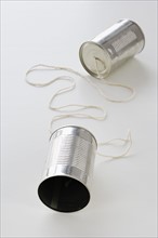 Tin cans connected by string.