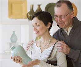 Couple looking at pottery in store.