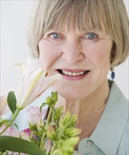 Close up of senior woman and flowers.