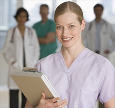 Female doctor holding chart.