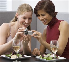 Two women looking at video camera.