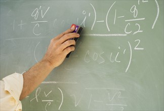 Professor erasing formulae on blackboard.