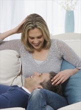 Man laying head in wife’s lap.