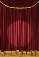 Spotlight on stage curtain.