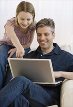 Father and daughter looking at laptop.
