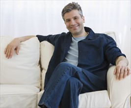 Man sitting on sofa.