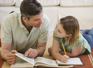 Father helping daughter with homework.
