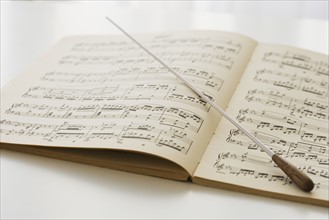 Conductor’s baton on sheet music.
