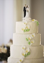 Wedding cake with bride and groom figurines.