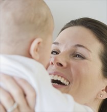 Mother laughing at baby.